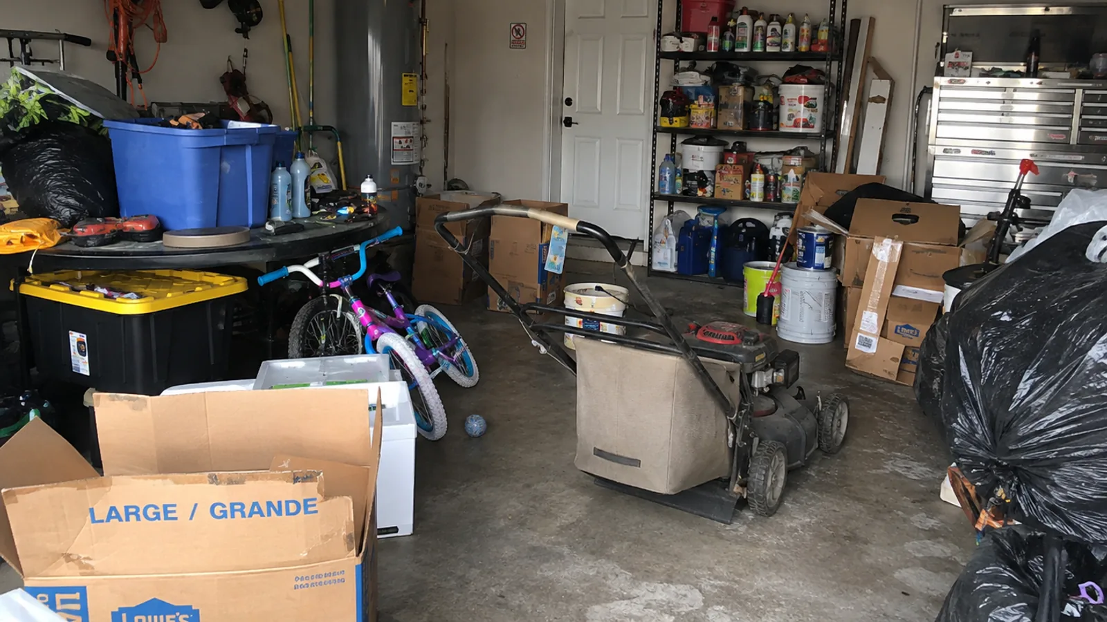 A Tulsa-area garage with boxes, tools, equipment, and household items ready to be sorted before a cleanout